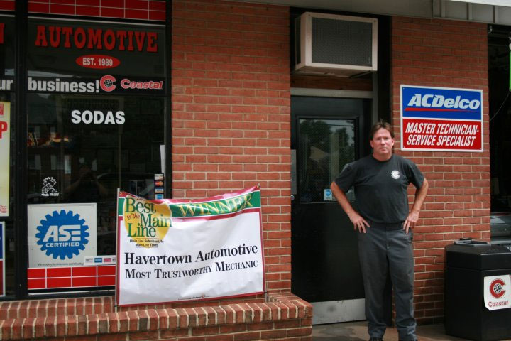 the owner outside his auto repair shop